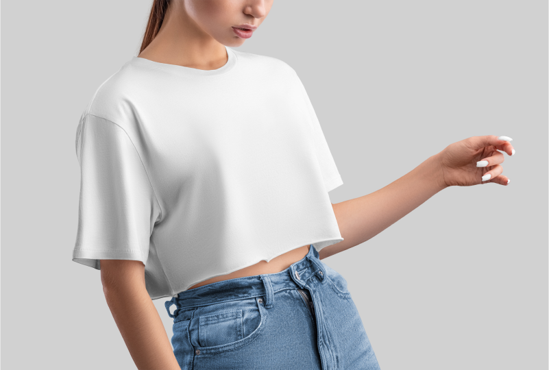 Woman in white crop top and jeans.