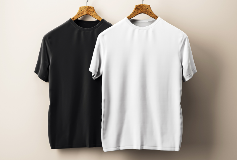 Black and white t-shirts on hangers.